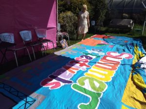 9 metre banner with the words 'Summer of Festivals' in rainbow colours